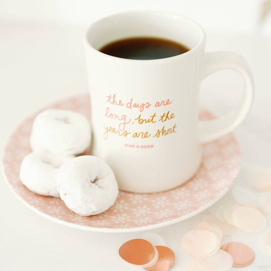 Buy one (1) affordable Mother's Day or Baby Shower gift. The white coffee mug says "the days are long, but the years are short"