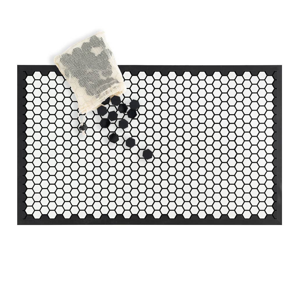 The white mat with black edging is a blank canvas. Make your own design using the black tile caps.