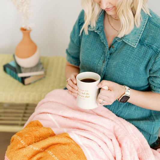 A mom is enjoying a quiet moment with her new coffee mug before a long day.