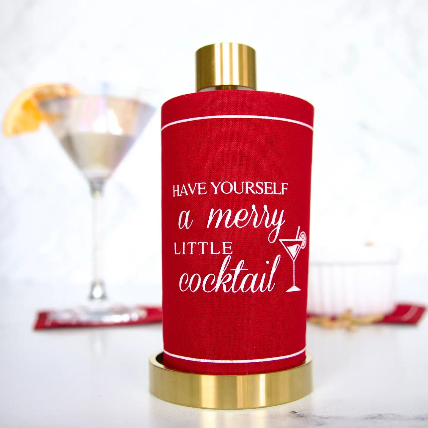Buy (1) set of 50 red cocktail napkins that say, "Have yourself a merry little cocktail," with a gold mini towel holder.