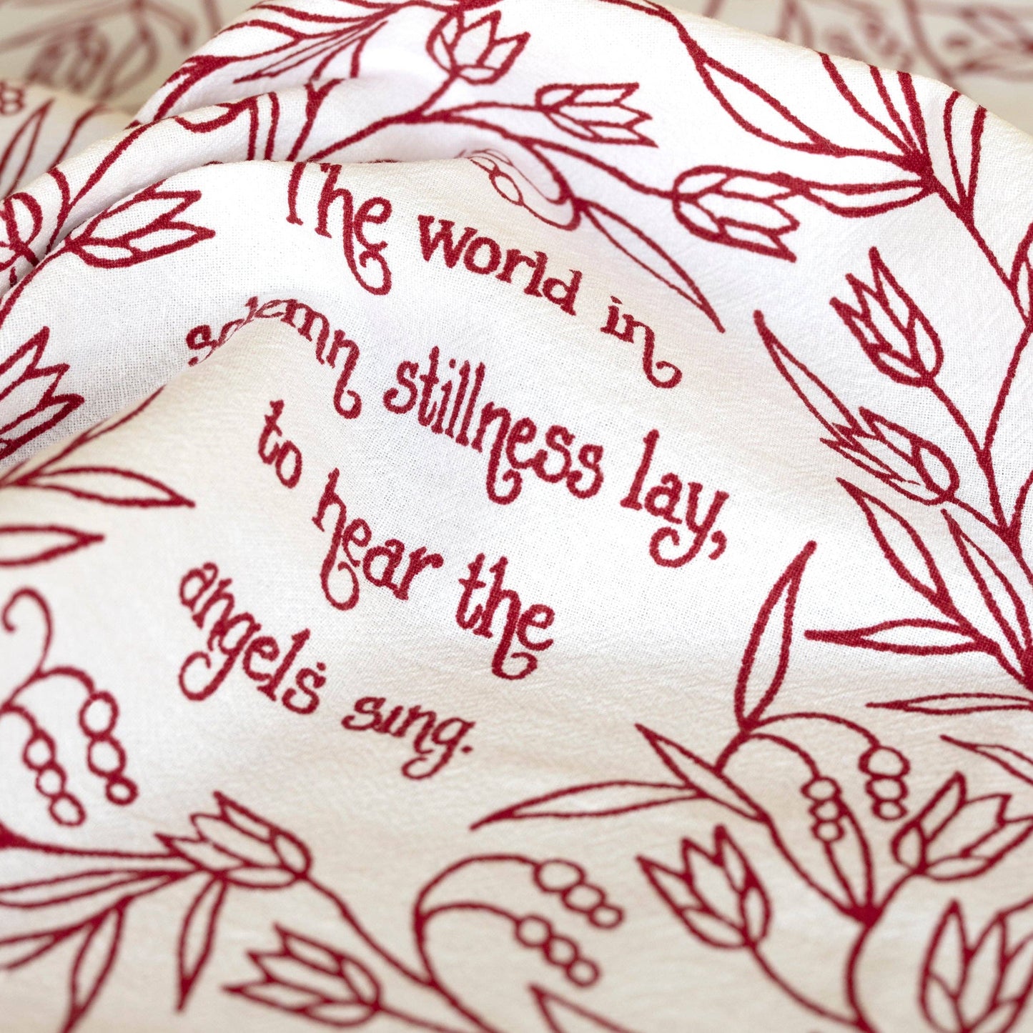 This tea towel says, "The world in solemn stillness lay, to hear the angels sing."