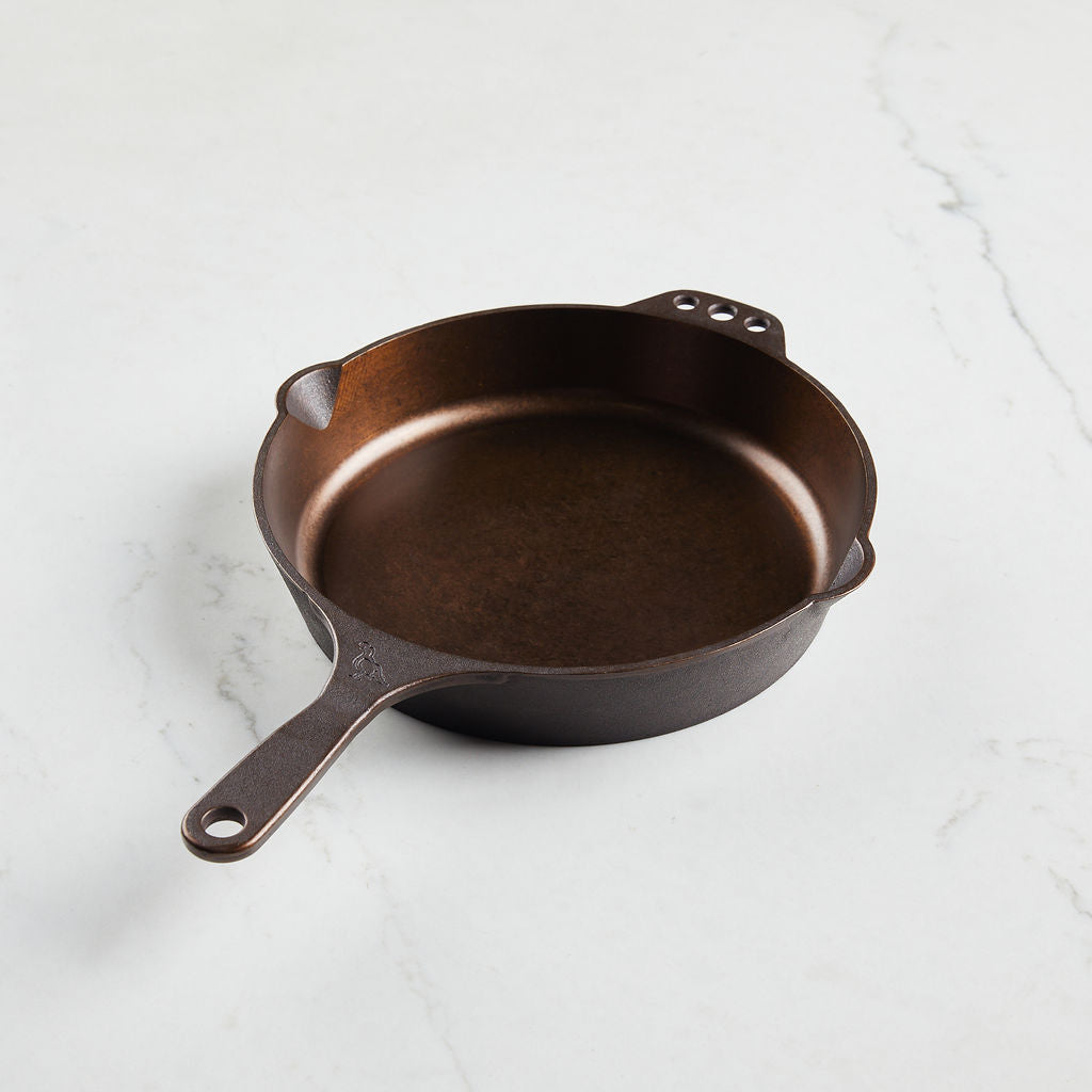 Buy one skillet with convenient holes for hanging.