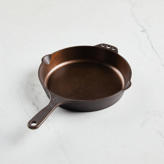 Buy one skillet with convenient holes for hanging.