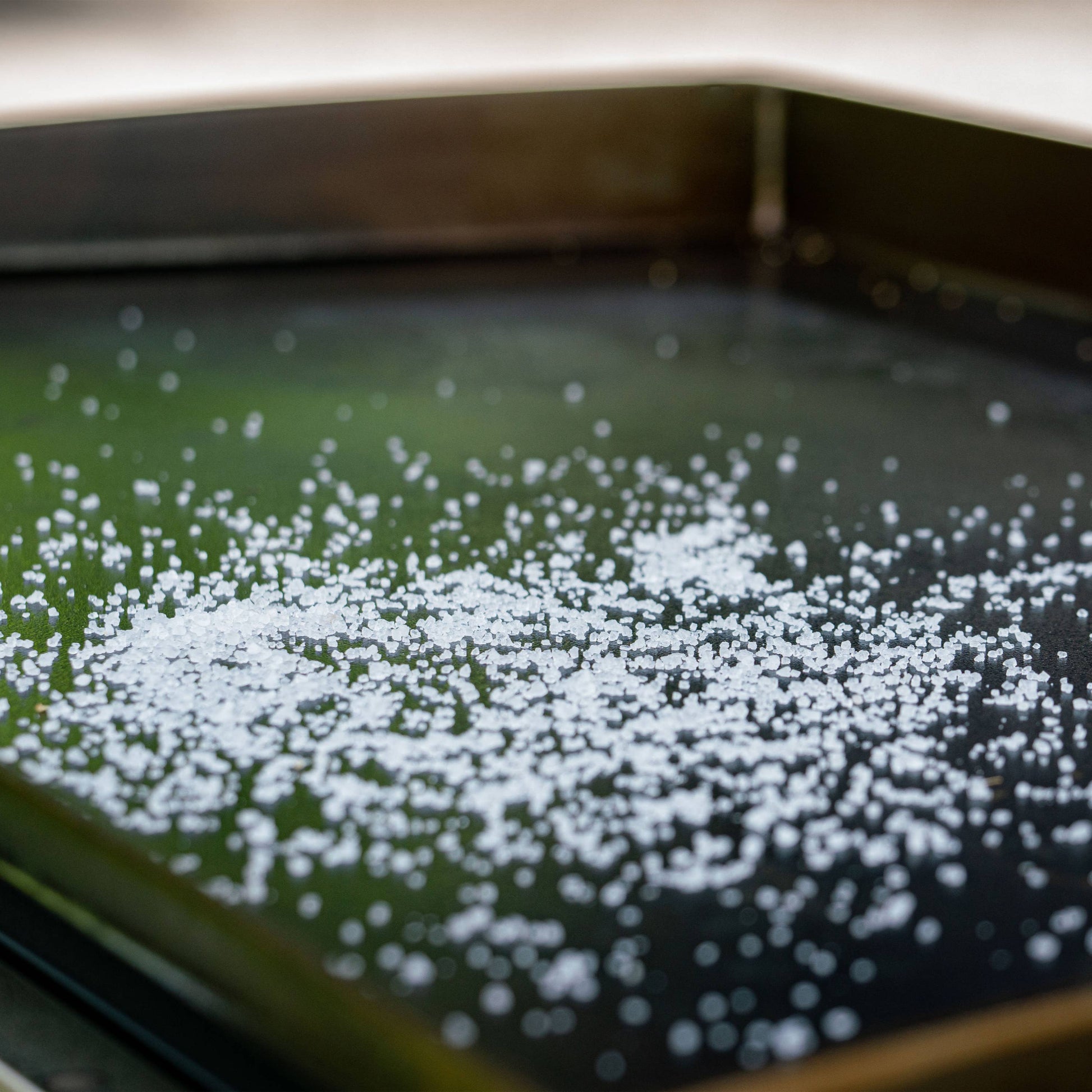 Sprinkle scrub salt and then rub with a rag to loosen burnt food while restoring your cooking surface.