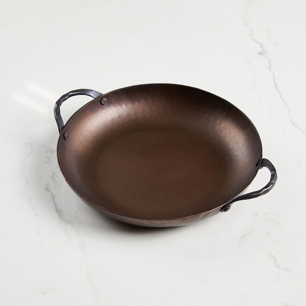 This hand-forged round roaster is 15" handle to handle, and has 9 inches of cooking surface.