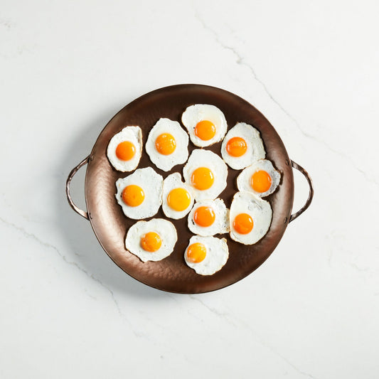 Buy one (1) carbon steel hand-forged round roaster.