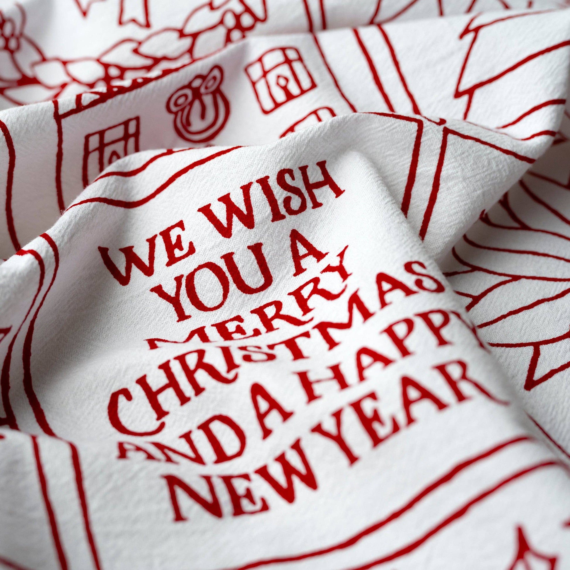 Beautiful red print on a white cotton towel will give your kitchen a festive holiday feel.