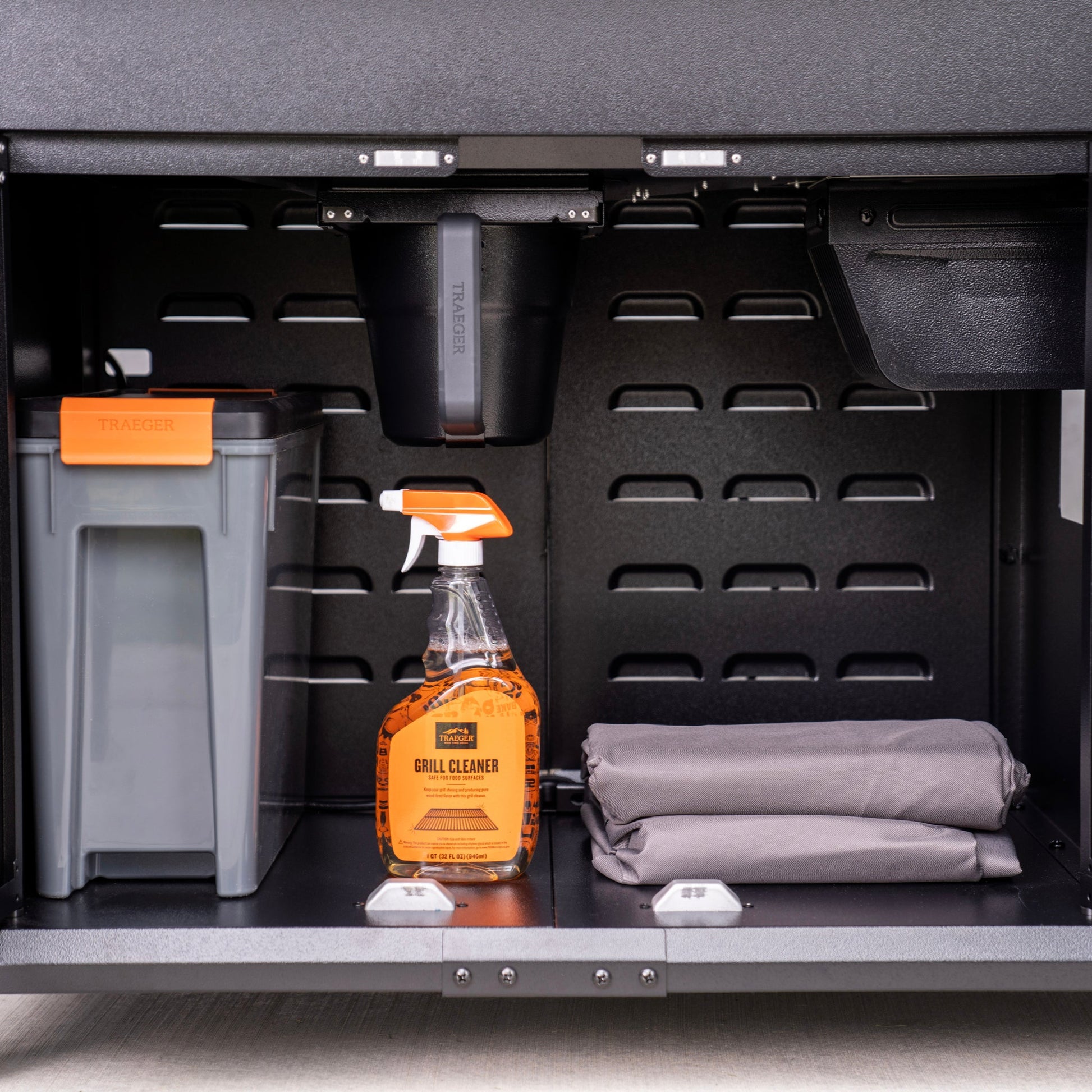 The Woodridge Elite keeps the ash collector tucked out of the way, plus has a compartment to keep pellets and your grill cover dry.