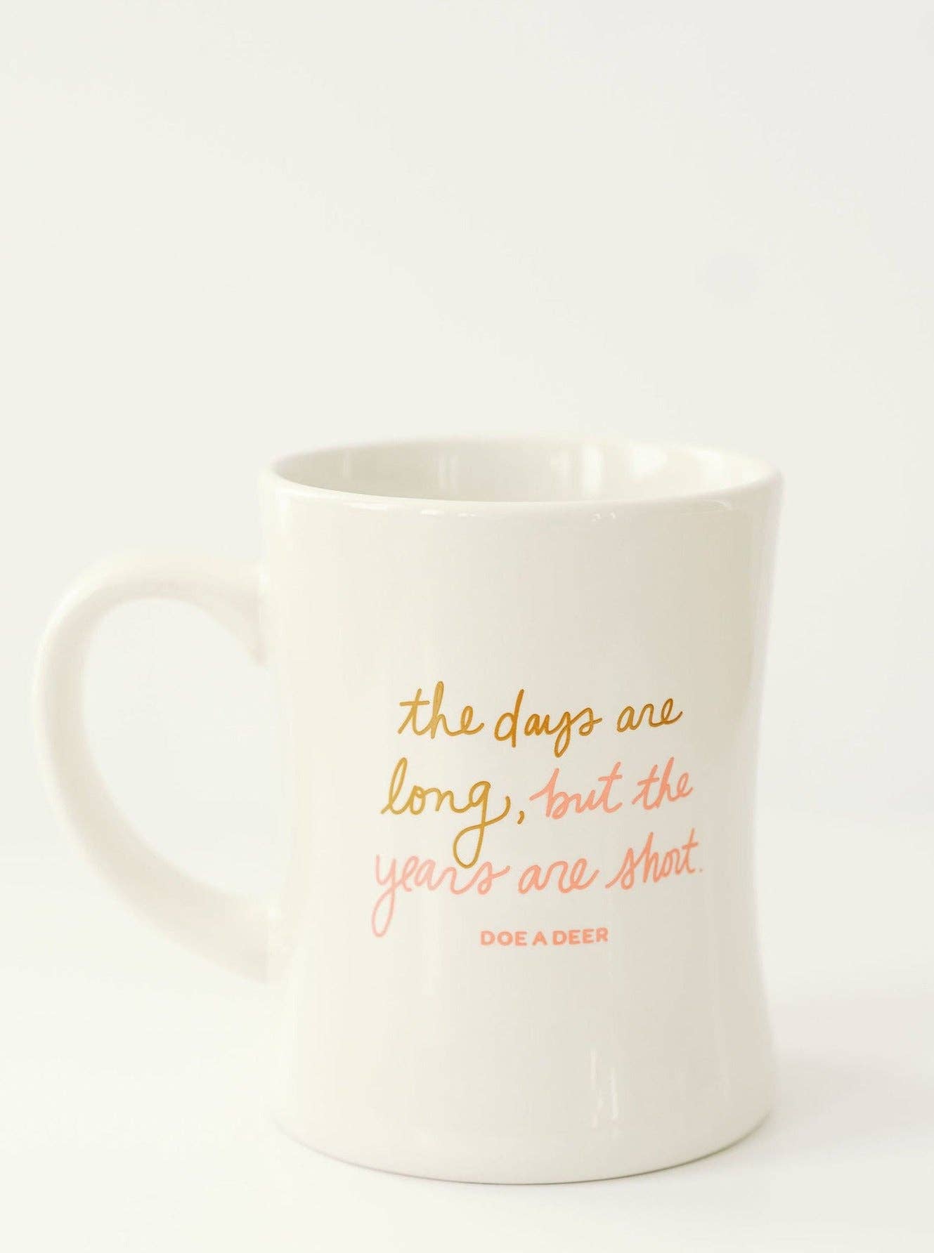This closeup shows the color of the text, a beautiful gold and coral combo on a white, modern coffee mug.