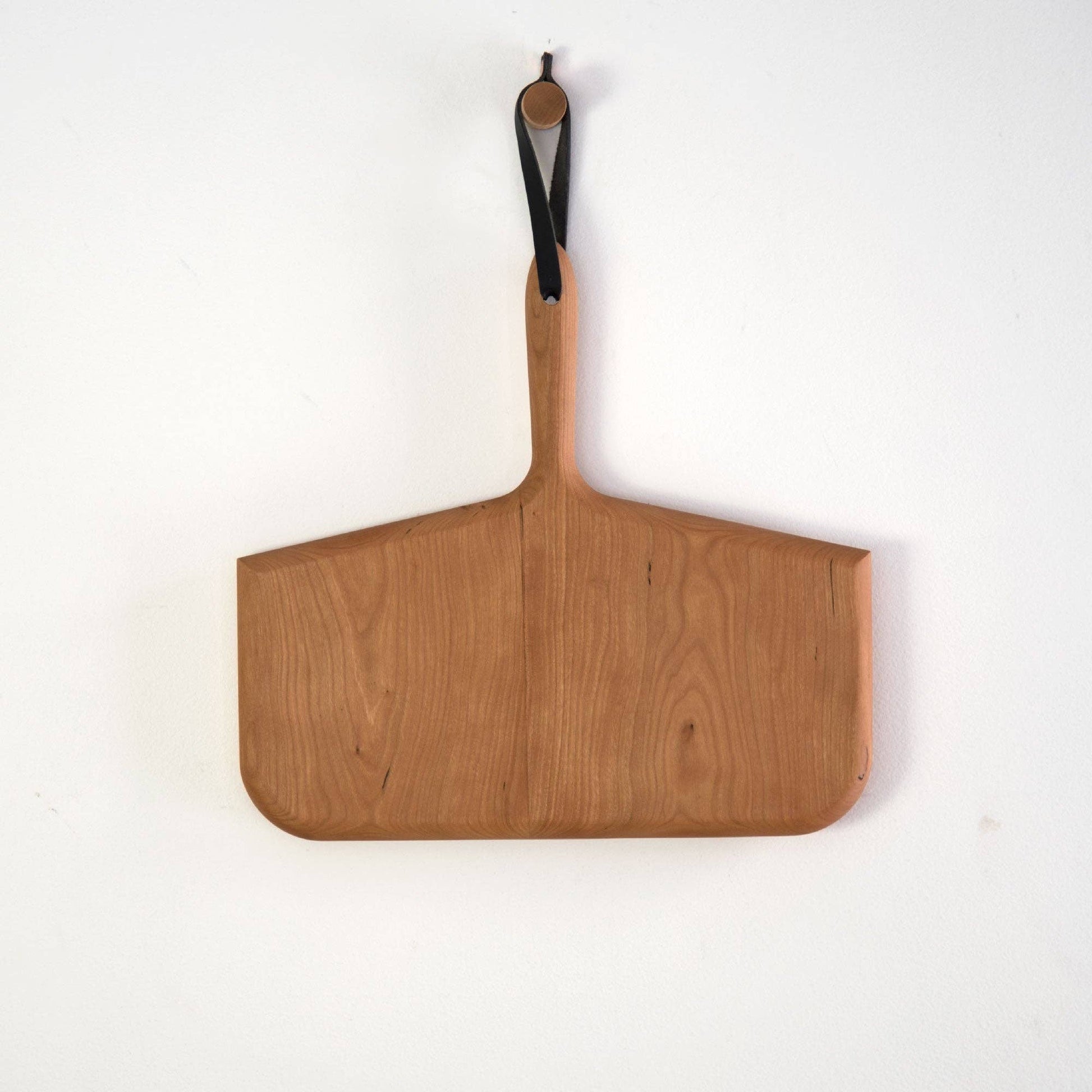 Buy one (1) whale bone cutting board carved from cherry wood.