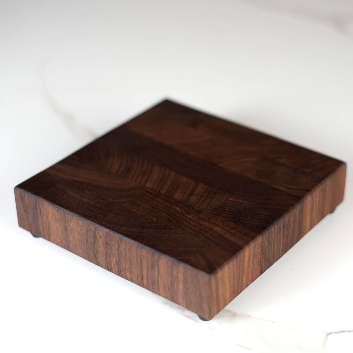 Square trivet made from end grain American walnut.