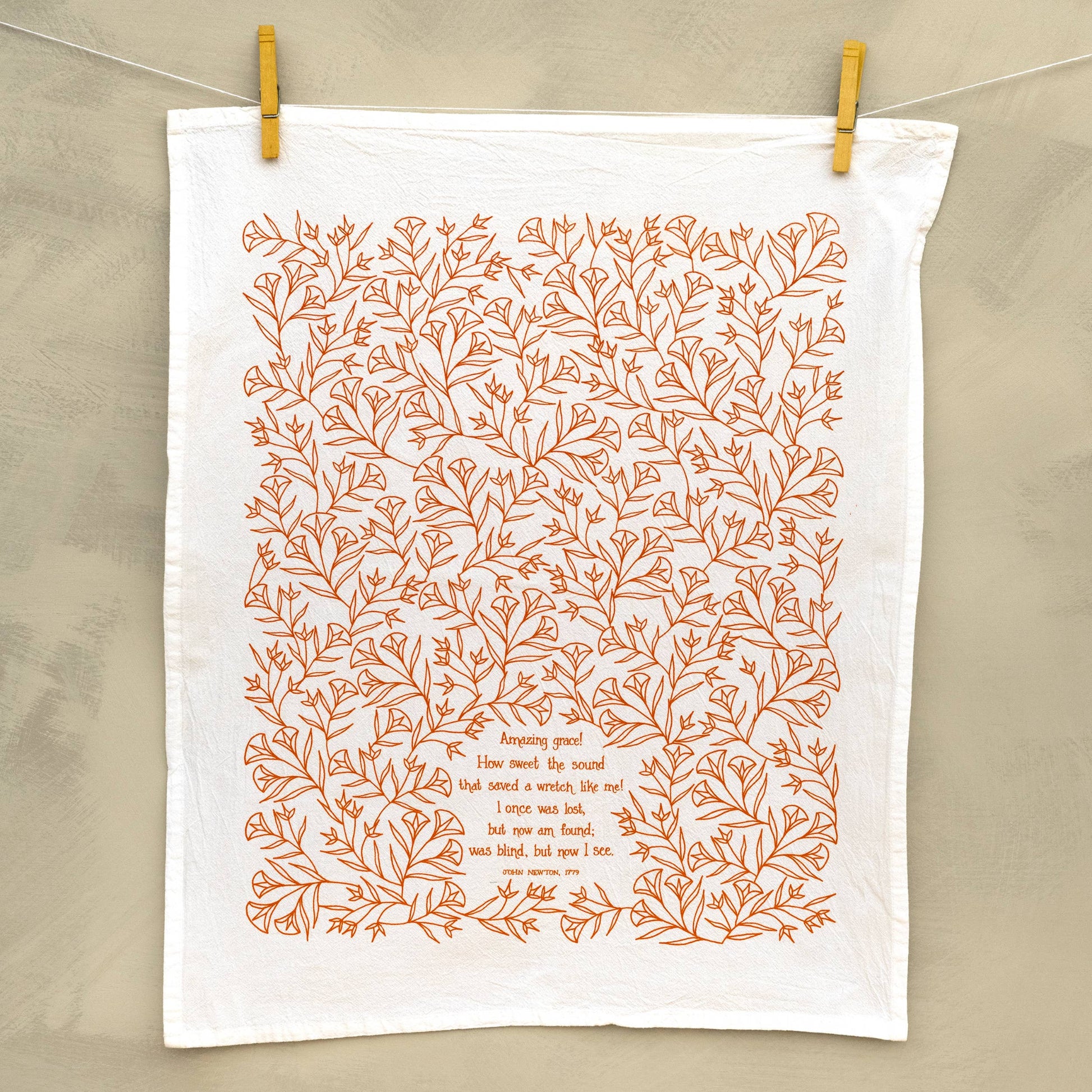 Buy 1 (one) generously sized cotton tea towel with lyrics from Amazing Grace and a beautiful marmalade color design illustration.