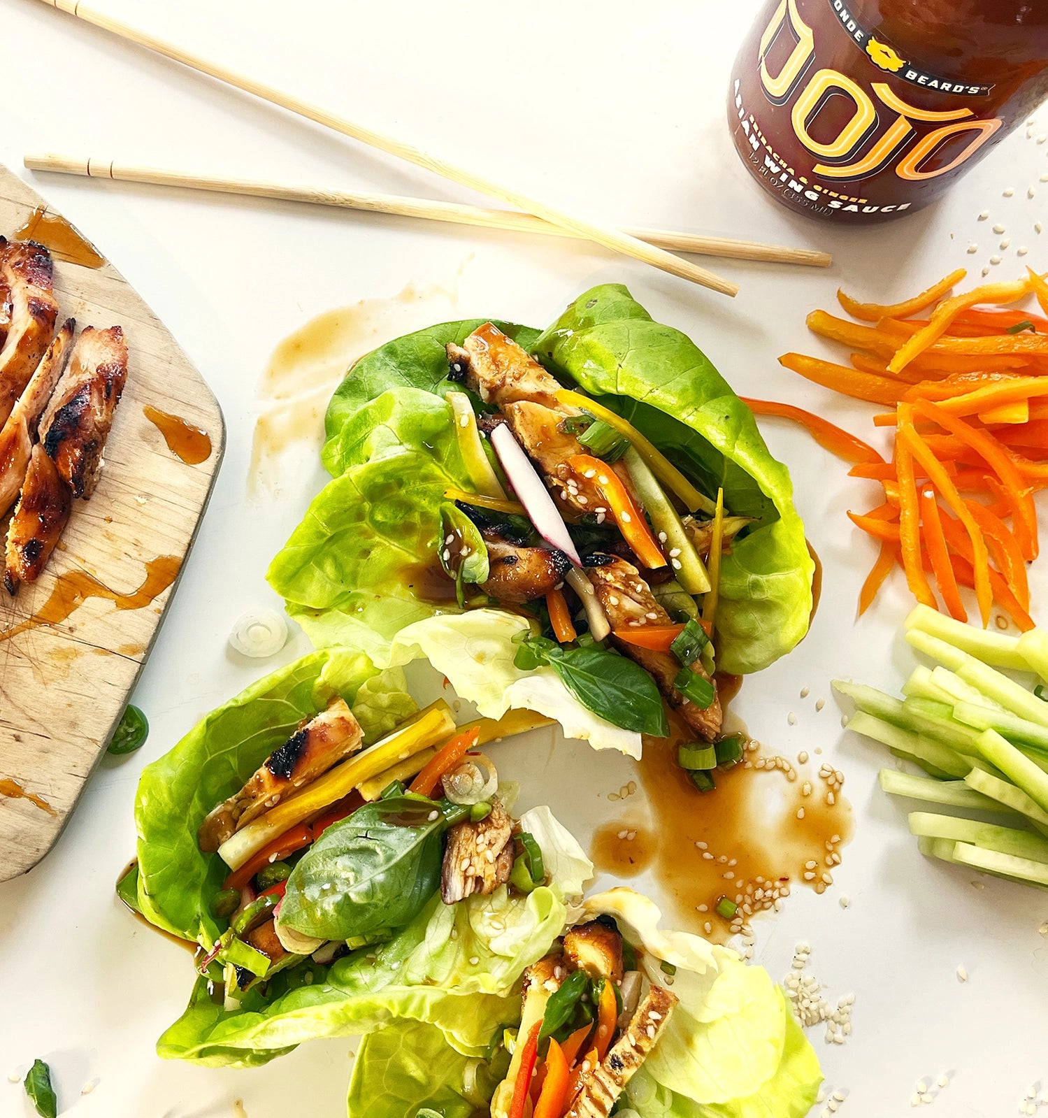 One (1) bottle of Dojo Asian Wing Sauce adds flavors of sriracha, ginger, sesame and soy sauce to liven up lettuce wraps.