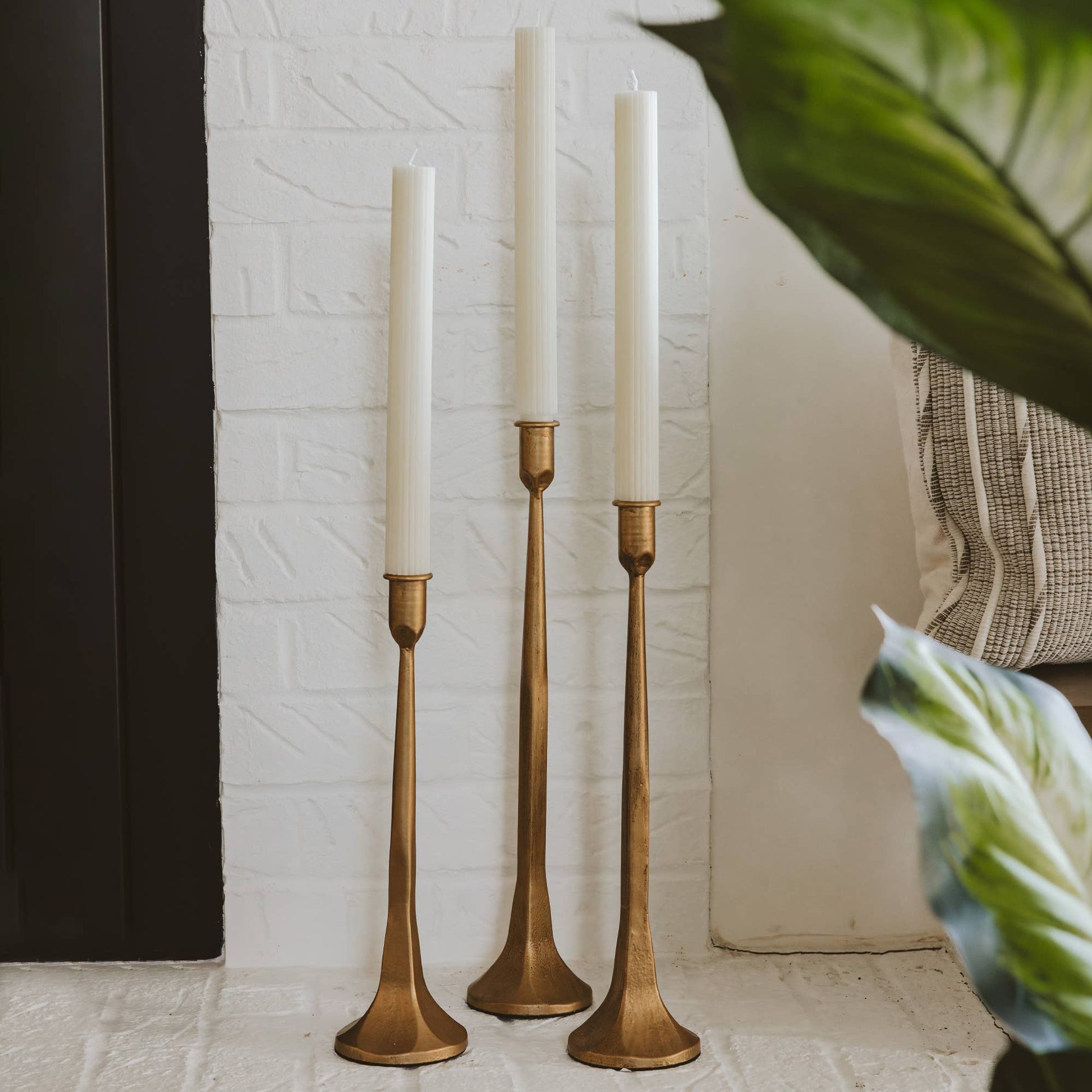 Style your mantle with this set of gold cast iron taper candle holders. (Candles sold separately.)