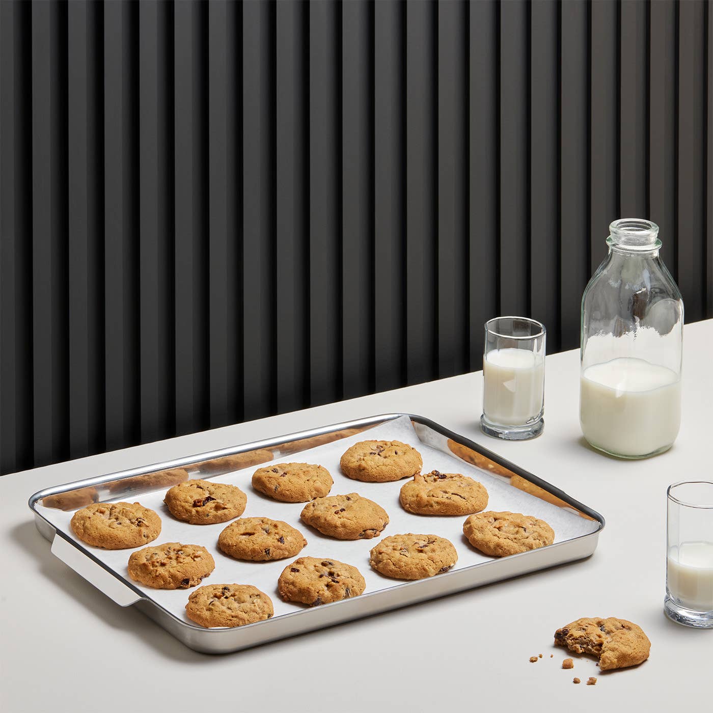Bake your famous chocolate chip cookies on this half sheet pan, which comes with a starter box of parchment paper. 