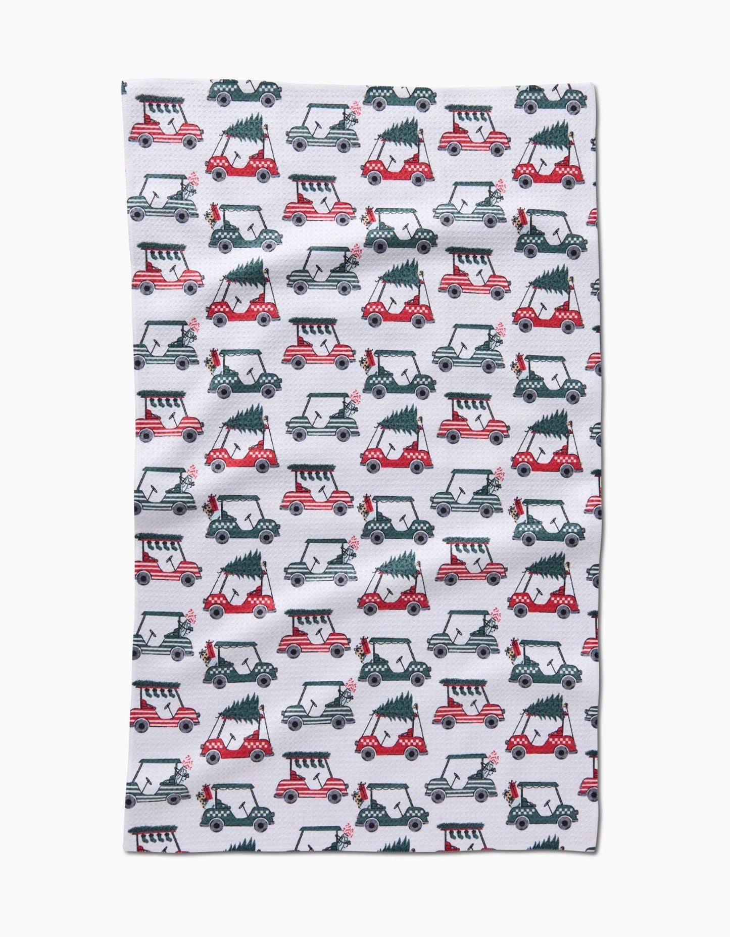 Buy 1 (one) tea towel featuring golf carts carrying trees and decorated for the holidays. 
