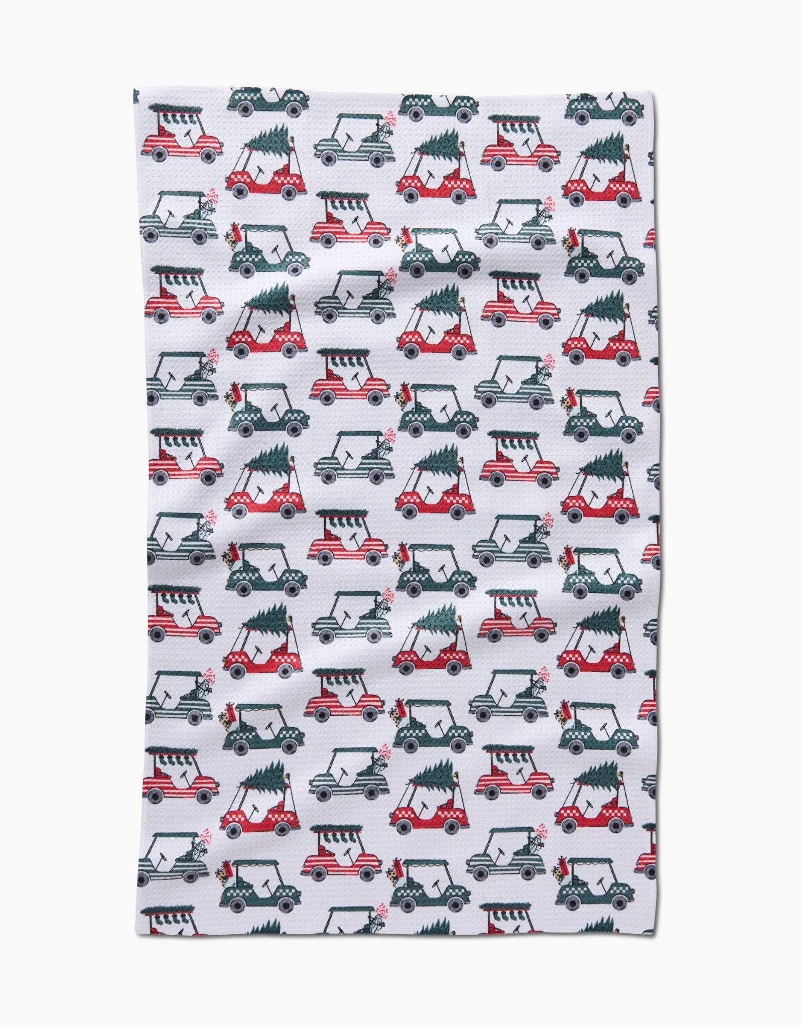 Buy 1 (one) tea towel featuring golf carts carrying trees and decorated for the holidays. 