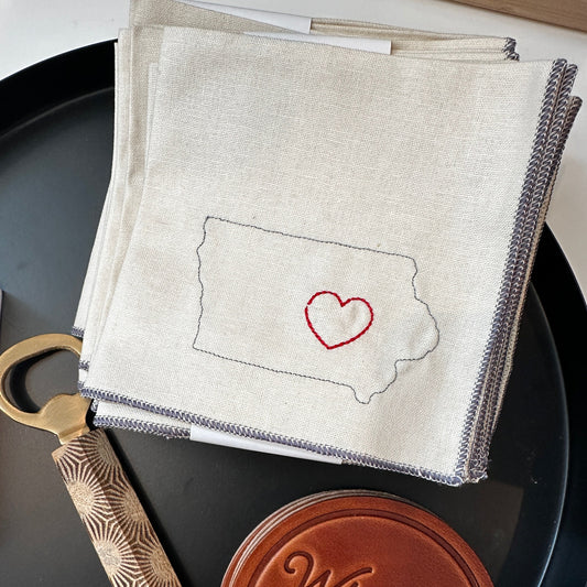 Shop one (1) set of four cocktail napkins, with a heart stitched around east central Iowa.