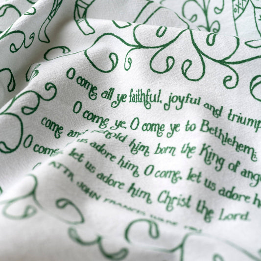 Beautiful evergreen text against a white cotton towel. 