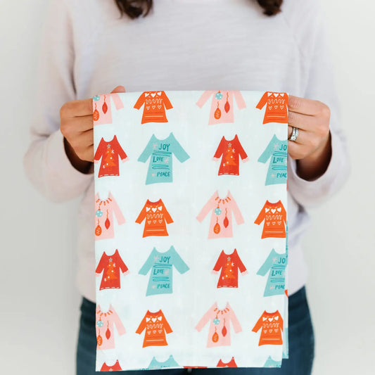 The entire towel is covered in cute sweaters.