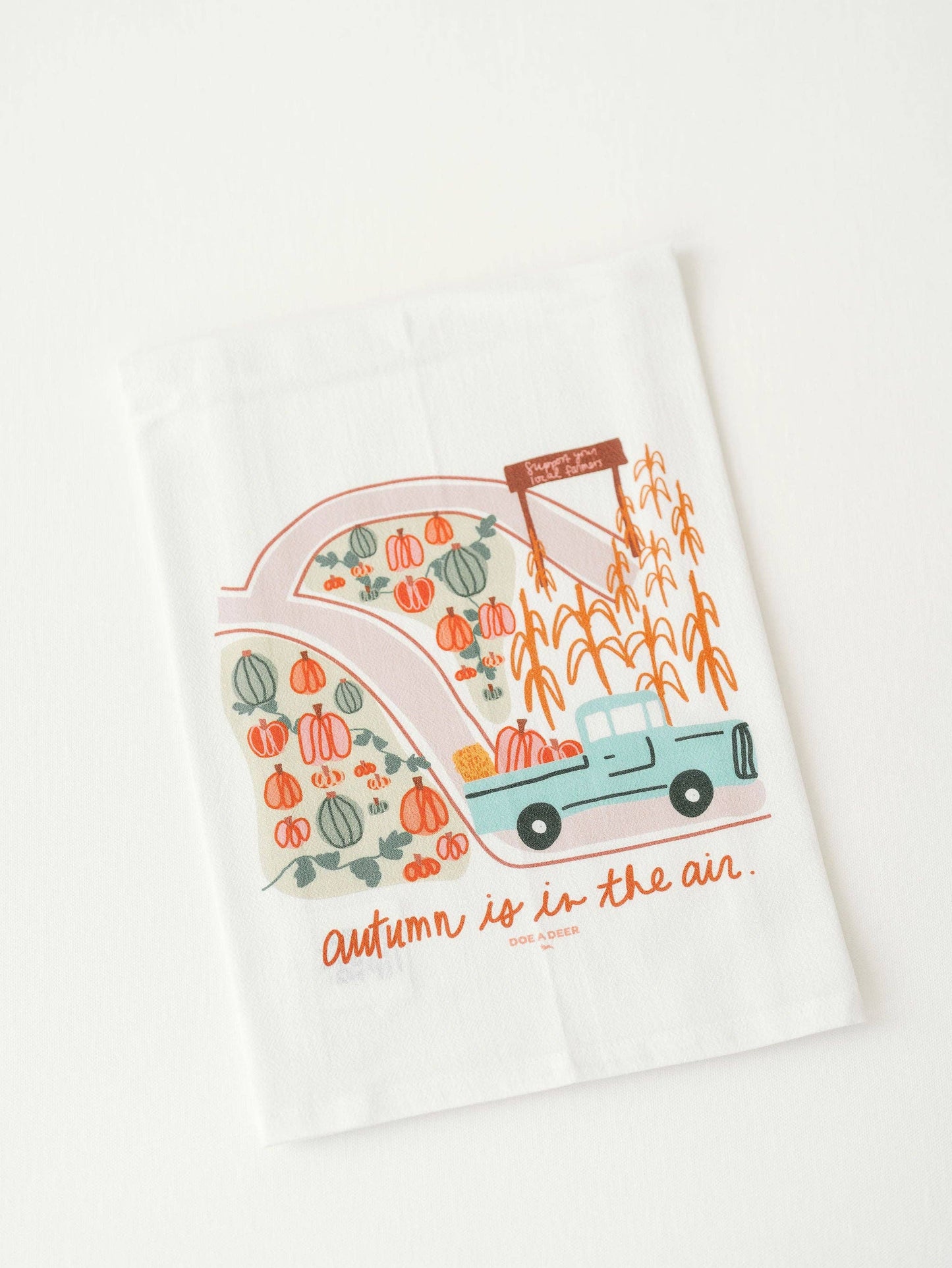 Buy one 100% cotton tea towel white, with colorful fall pumpkin stand print.