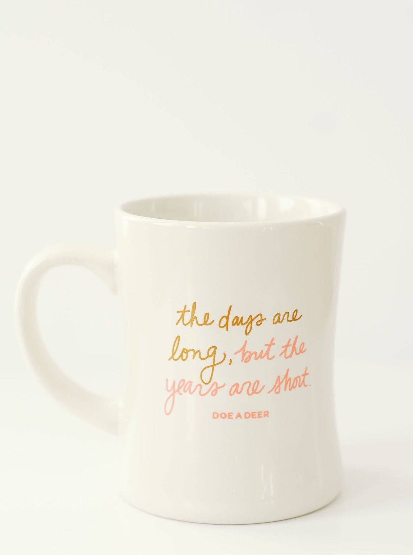 This closeup shows the color of the text, a beautiful gold and coral combo on a white, modern coffee mug. 