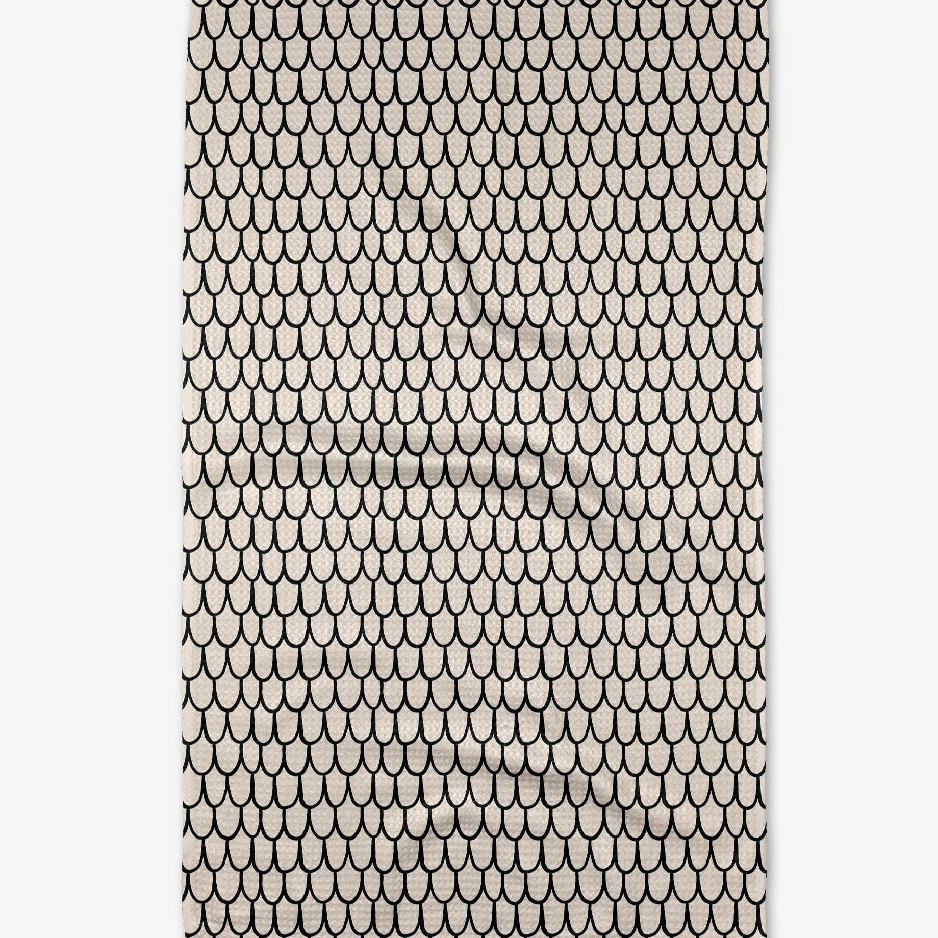 Buy one (1) cream colored tea towel with a repeating fish scale pattern.