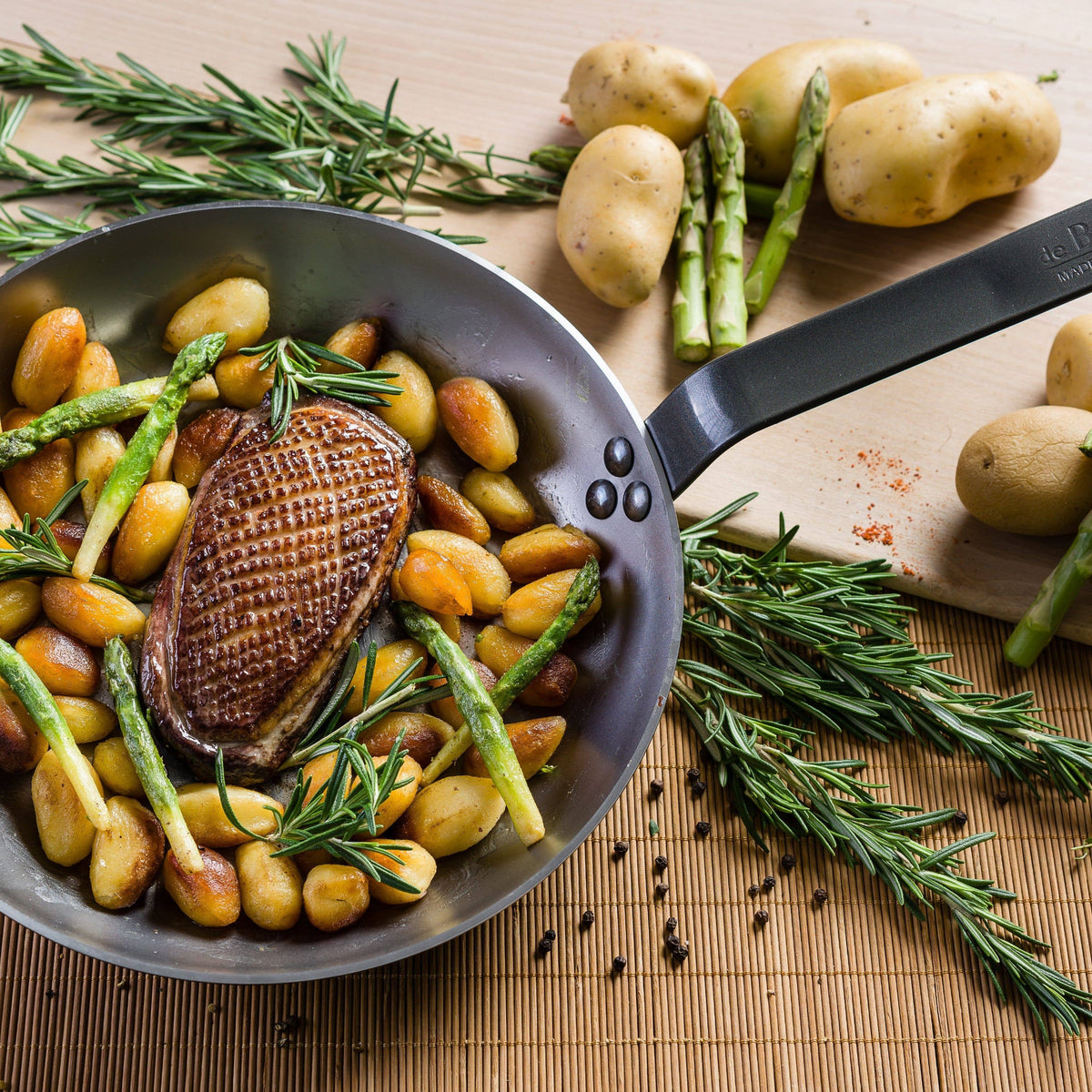 A perfectly cooked duck breast and vegetables are ready to serve in the de Buyer MINERAL skillet.